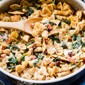 One Pot Creamy Sun Dried Tomato and Spinach Pasta with Chicken is an easy to make dinner the whole family will love! You won't believe there isn't a drop of cream in this flavorful, healthy pasta dish!