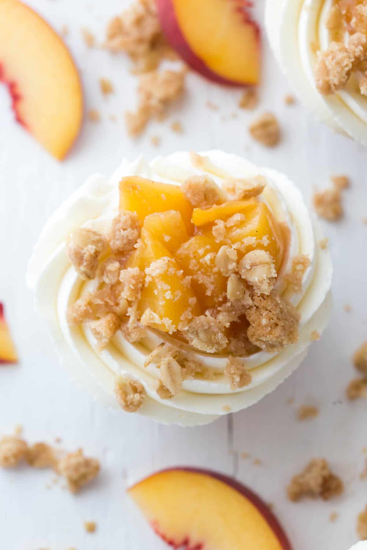 A close up photo of a peach pie cupcake on a white countertop.