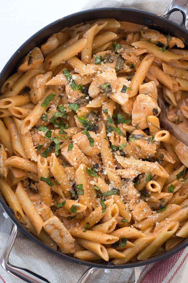 One Pot Creamy Tomato Pasta with Chicken and Spinach comes together in 35 minutes! The entire meal cooks in one pot and creates a dish that kids and adults love.