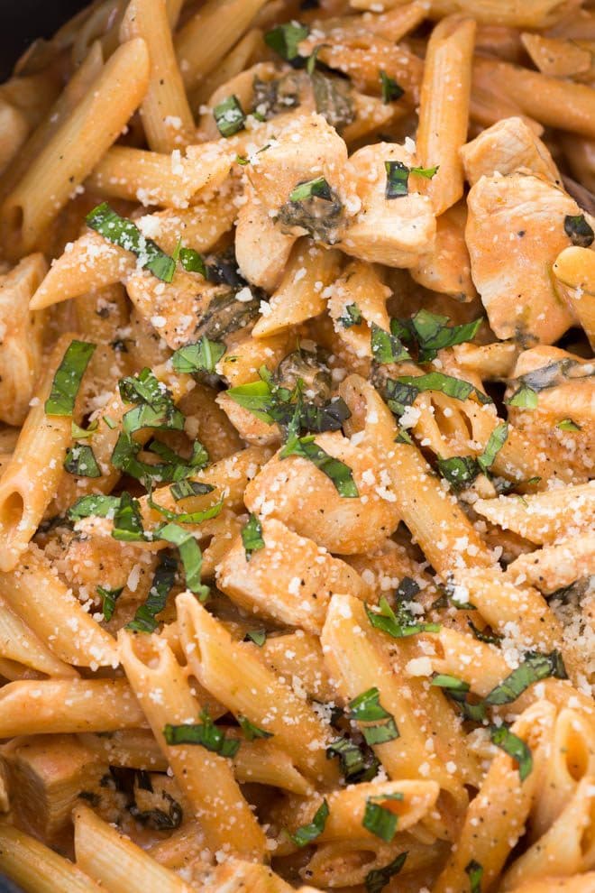 One Pot Creamy Tomato Pasta with Chicken and Spinach comes together in 35 minutes! The entire meal cooks in one pot and creates a dish that kids and adults love.