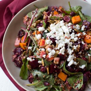 Roasted Sweet Potato, Beet, Apple and Quinoa Salad is made with fresh greens, vegetables, spiced pepitas, dried cranberries, goat cheese and a simple balsamic honey dressing!