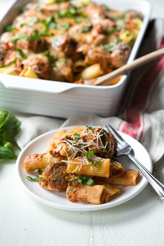Baked Rigatoni Pasta with Spinach and Meatballs is the perfect meal for any day of the week! The recipe is made with rigatoni, mini meatballs, spinach, creamy tomato sauce and plenty of mozzarella and parmesan cheese. #pastabake #recipe #dinner #weeknightmeal #meatballs