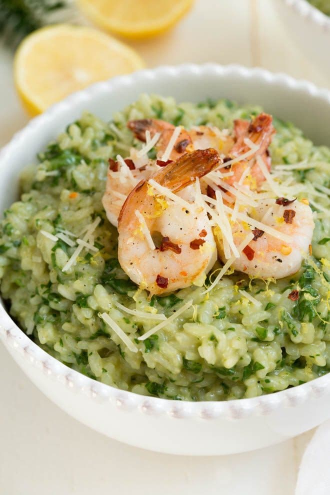 Lemon Garlic and Spinach Risotto is a classic recipe that combines everything you love about creamy risotto with lemon garlic and hearty spinach. The creamy risotto is topped with a simple sautéed lemon garlic shrimp to create an entire meal for any day of the week!
