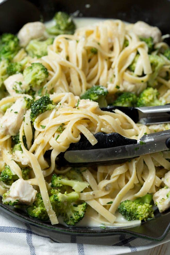 Lightened Up One Pan Chicken and Broccoli Fettuccine Alfredo is a healthier twist on classic chicken Alfredo pasta. It is cooked in one pan and lightened up to make it an easy yet satisfying meal for any day of the week!