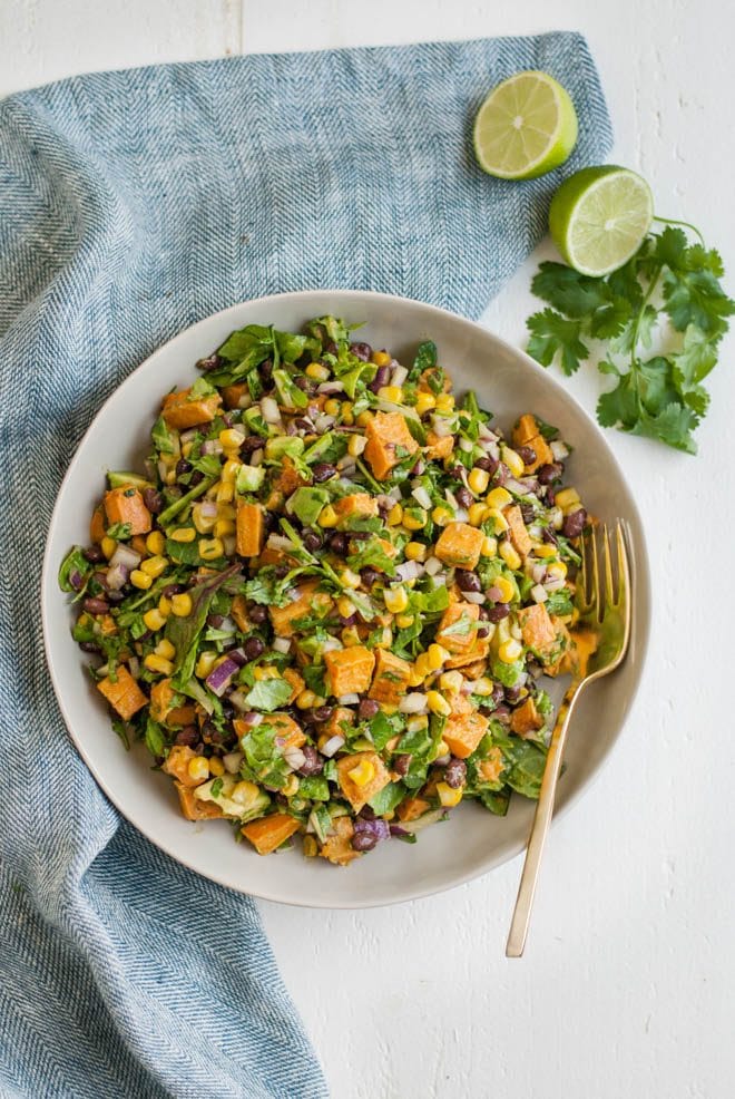 Southwest Sweet Potato Chopped Salad is made with roasted sweet potatoes, black beans, corn, red onion, avocado and chopped greens. It is served with fresh avocado cilantro dressing! #southwest #sweetpotato #chopped #salad #healthy #recipe #organicgirl #avocado #cilantro #dressing #healthyrecipe #lunch #dinnerv