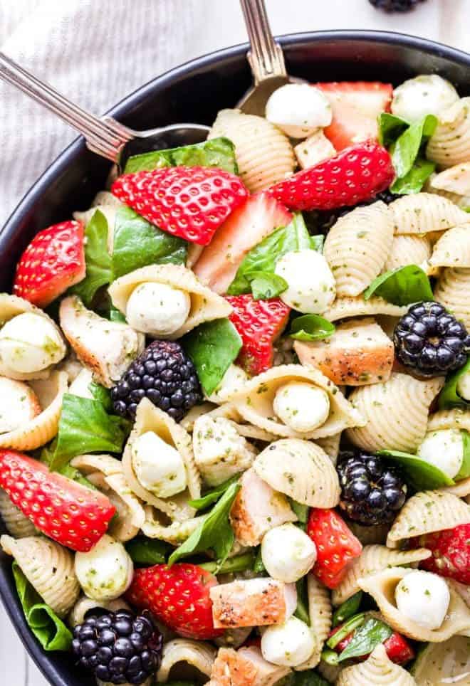 This Chicken and Berry Pesto Pasta Salad is a flavorful and easy to make main dish salad. All the flavors of caprese salad, but using berries instead of tomatoes! #pastasalad #pesto #strawberries #chicken