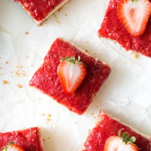 Mango Strawberry Cheesecake Bars are an irresistible treat made with ripe mango, strawberries, cream cheese, sour cream and a few other simple ingredients. They are the perfect summer dessert and combine a light and creamy mango cheesecake with strawberry topping! #mango #cheesecake #strawberry #bars #dessert #summerrecipe #dessertrecipe #recipe