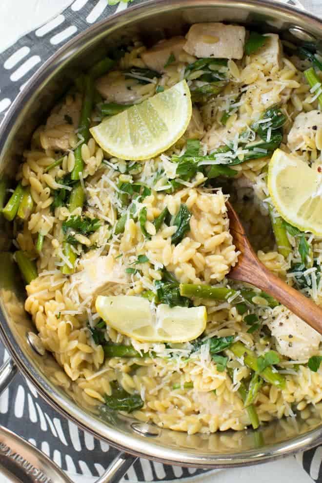 skillet with creamy orzo pasta and chicken, asparagus and spinach