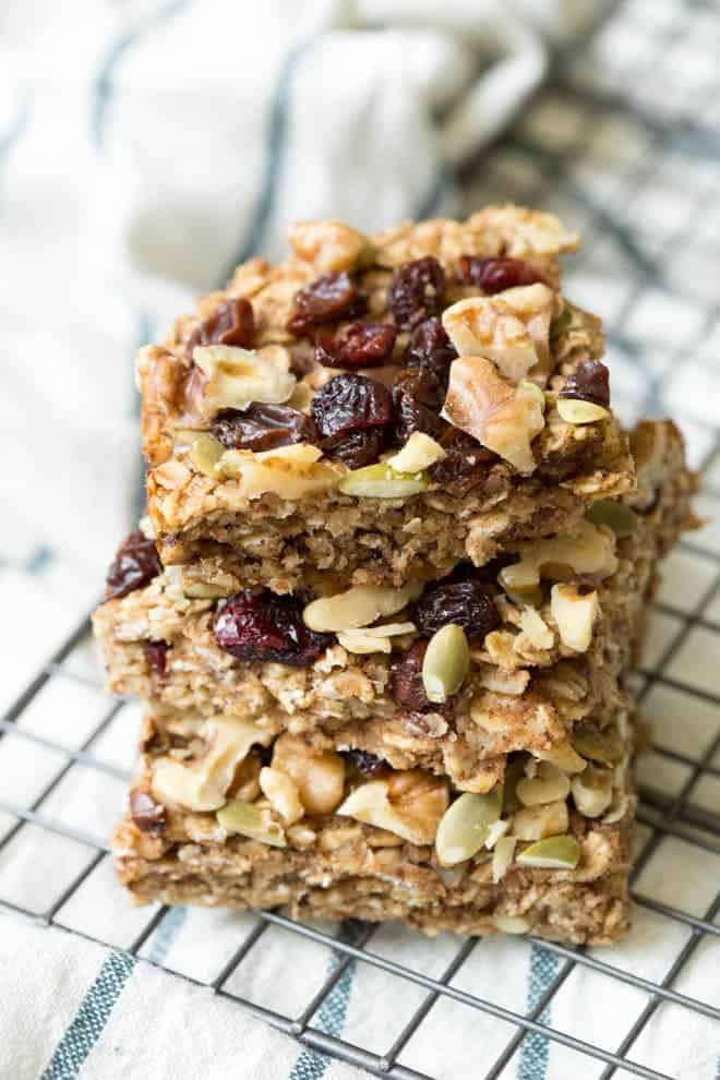 a stack of three trail mix breakfast bars sitting on a baking rack