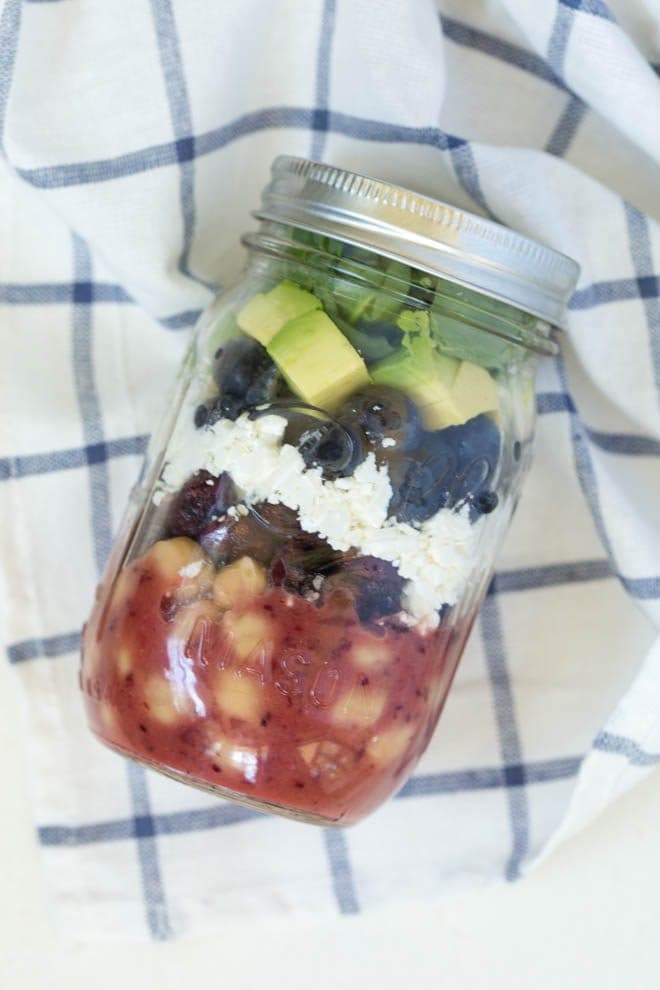 Combine the freshest flavors to create this Cranberry Blueberry and Goat Cheese Salad with Cranberry Vinaigrette Dressing. Pack in a mason jar for on-the-go or serve in a large bowl for a crowd. This antioxidant packed salad will please everyone! #masonjar #clean #recipe #salad