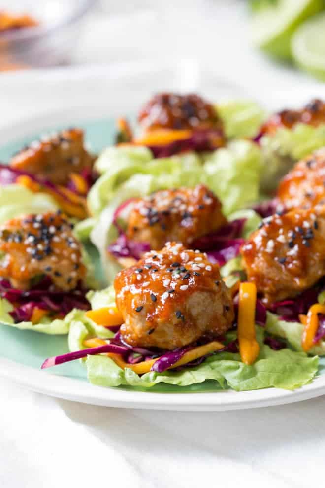 Wrap saucy chicken meatballs and fresh mango slaw with crunchy butter lettuce to create these Asian Chicken Meatball Lettuce Wraps with Mango Slaw! Enjoy them for lunch, dinner or as an appetizer. #chicken #meatballs #dinner #lunch #appetizer #asian #healthy #recipe #mango