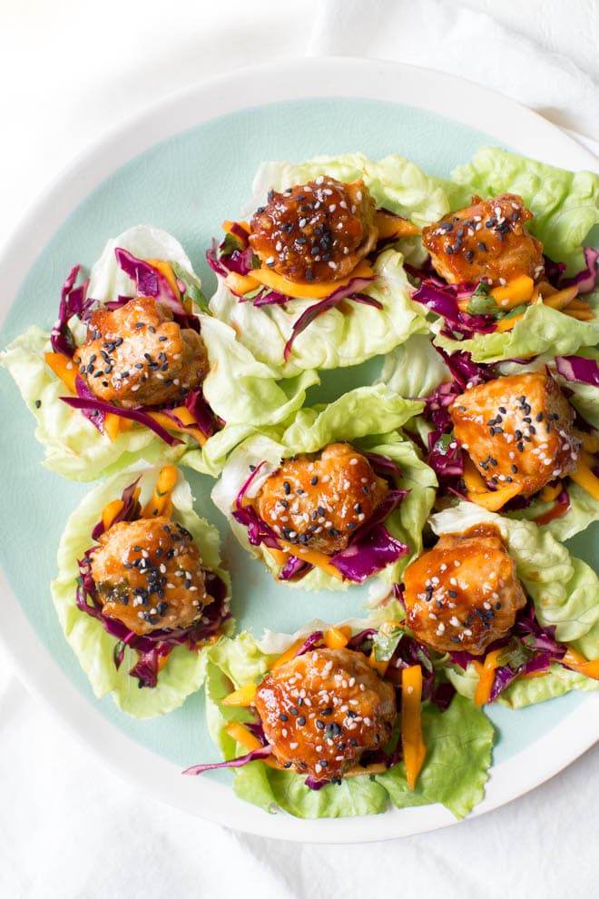 Wrap saucy chicken meatballs and fresh mango slaw with crunchy butter lettuce to create these Asian Chicken Meatball Lettuce Wraps with Mango Slaw! Enjoy them for lunch, dinner or as an appetizer. #chicken #meatballs #dinner #lunch #appetizer #asian #healthy #recipe #organicgirl