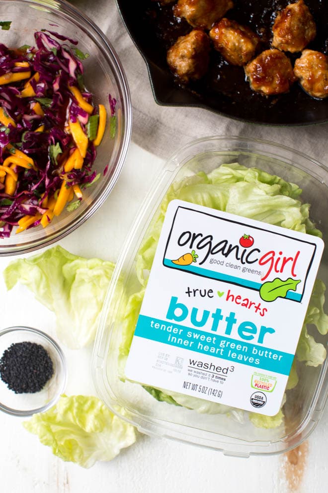 Wrap saucy chicken meatballs and fresh mango slaw with crunchy butter lettuce to create these Asian Chicken Meatball Lettuce Wraps with Mango Slaw! Enjoy them for lunch, dinner or as an appetizer. #chicken #meatballs #dinner #lunch #appetizer #asian #healthy #recipe #organicgirl