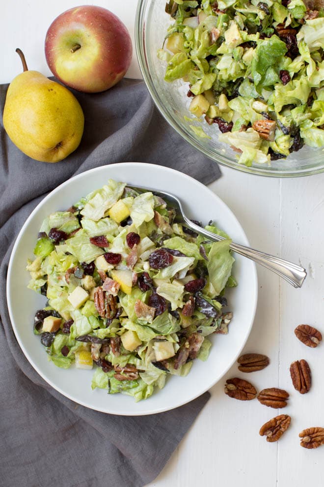 Autumn Chopped Salad is made with the freshest fall flavors including apples, pears, cranberries, bacon, avocado, butter greens and a creamy white cheddar dressing! #apple #pear #autumn #fall #salad #healthy #organicgirl #greens #fall #recipe
