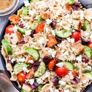 This Greek Chicken Pasta Salad is a healthy main dish pasta salad that's delicious any time of year! Loaded with cucumbers, tomatoes, kalamata olives and of course, plenty of feta cheese! #pastasalad #greek #chicken #healthydinner