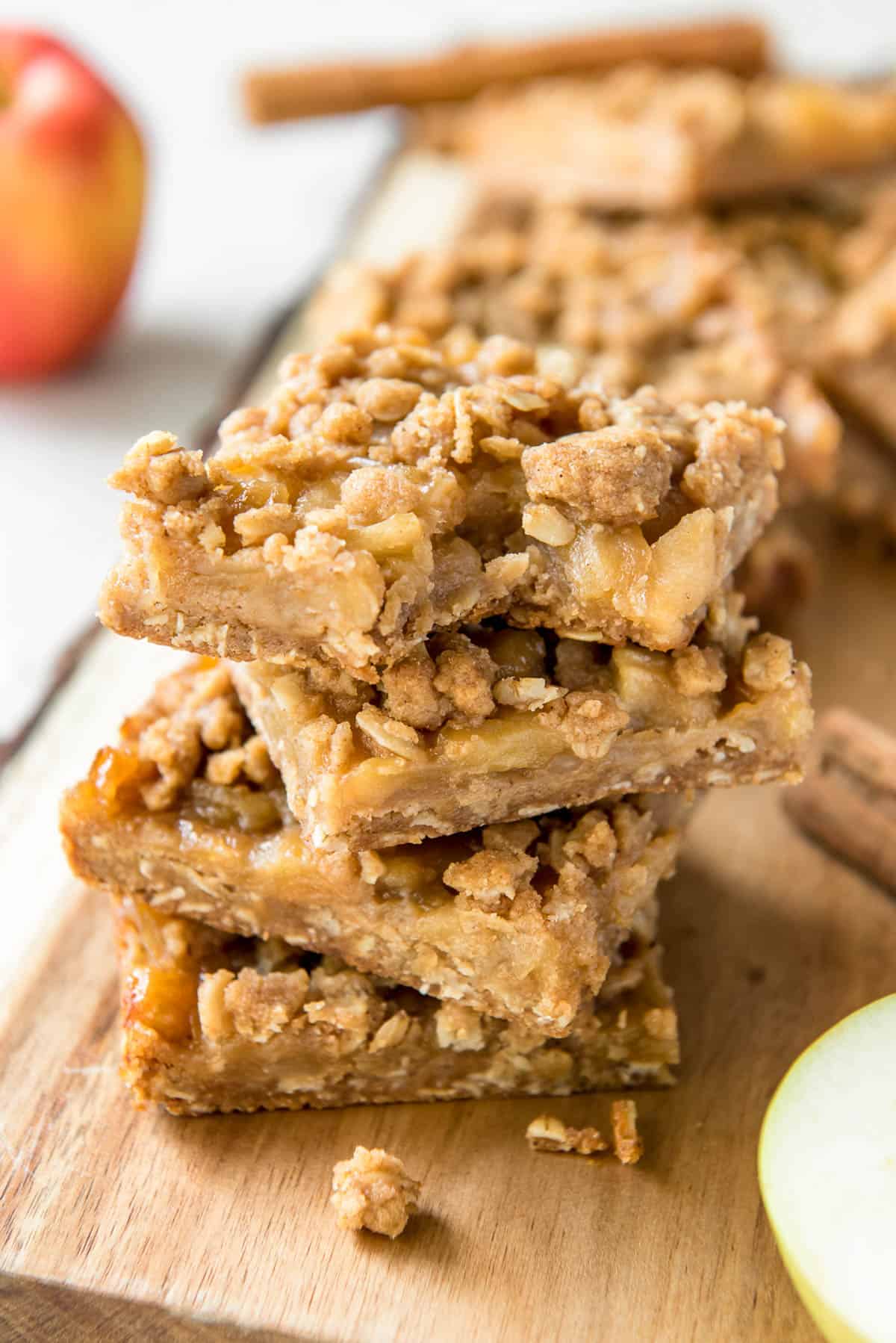 a stack of apple crumb bars sitting on a cutting board