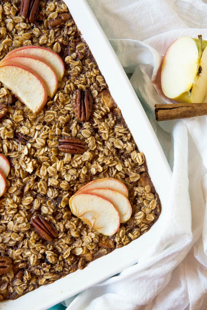 Baked oatmeal with apples and pecans in a casserole dish
