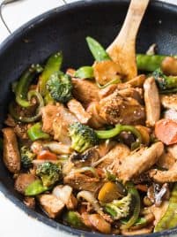 Garlic Sesame Chicken Stir Fry is an easy meal that’s on the table in 30 minutes or less and boasts an authentic Chinese stir-fry flavor! Skip take out to make this healthier stir fry at home. #sesame #chicken #stirfry #dinner #recipe #skillet