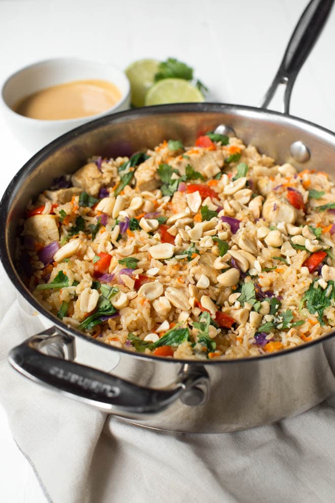 Thai Chicken Peanut Rice Skillet is an easy one pot meal that cooks in less than 30 minutes! It's packed with red bell peppers, carrots, cabbage, baby bok choy, chicken, rice and a creamy peanut sauce. #chicken #peanut #skillet #dinner #weeknight #meal #onepot