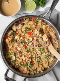 Thai Chicken Peanut Rice Skillet is an easy one pot meal that cooks in less than 30 minutes! It's packed with red bell peppers, carrots, cabbage, baby bok choy, chicken, rice and a creamy peanut sauce. #chicken #peanut #skillet #dinner #weeknight #meal