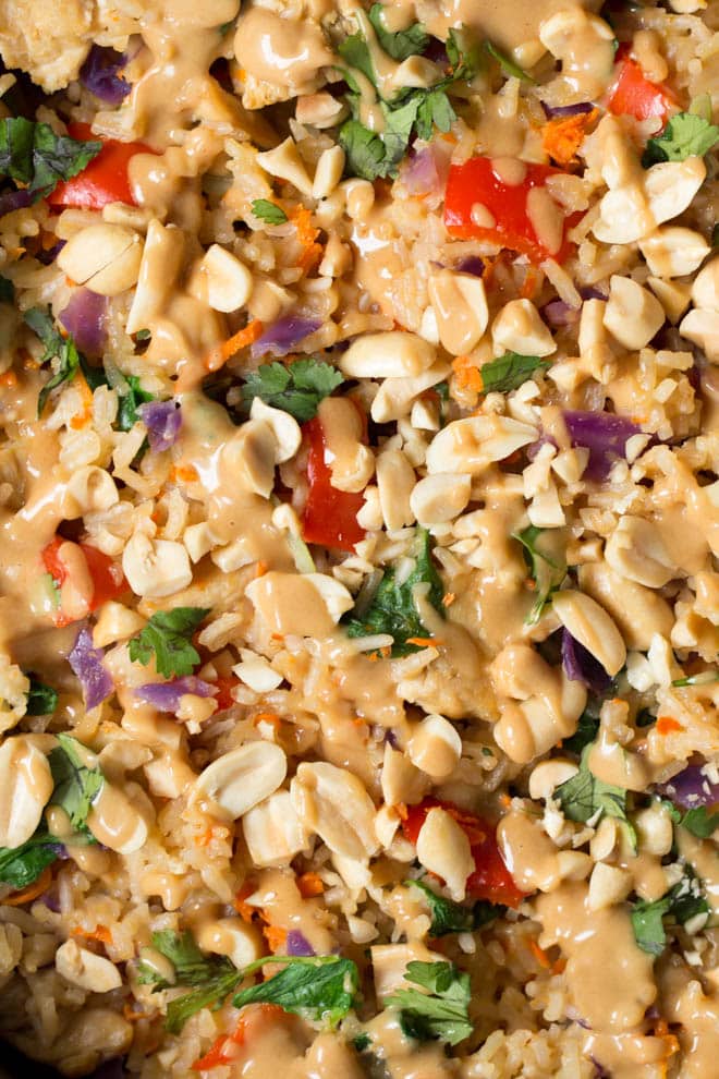 Thai Chicken Peanut Rice Skillet is an easy one pot meal that cooks in less than 30 minutes! It's packed with red bell peppers, carrots, cabbage, baby bok choy, chicken, rice and a creamy peanut sauce. #chicken #peanut #skillet #dinner #weeknight #meal #onepot #easyrecipe