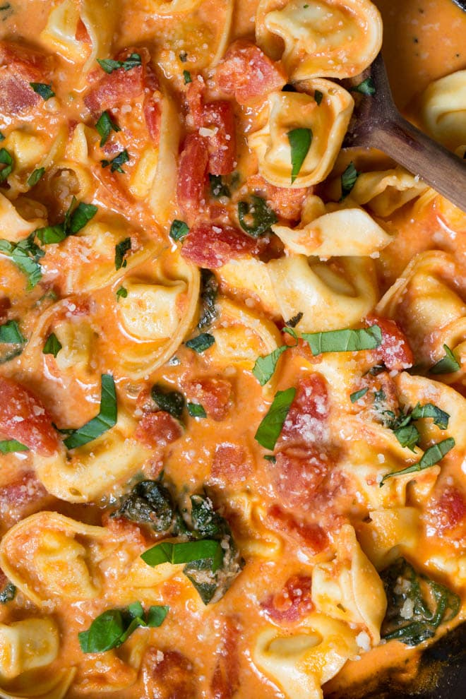 Combine a few simple ingredients to create a Creamy Tomato Basil Tortellini Skillet made in less than 30 minutes! The skillet is packed with fresh flavor and hearty ingredients. #tomato #basil #tortellini #pasta #skillet #dinner #recipe