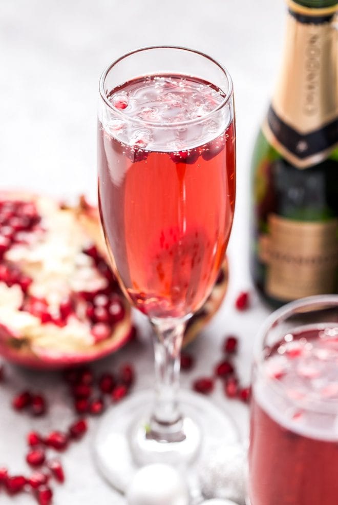 Pomegranate French 75 is the perfect drink to toast with this holiday season and a must for brunch! Bubbly, sweet and floral with a touch of tart flavor from the pomegranate. #French75 #pomegranate #cocktail #champagne #christmas #newyearseve #valentinesday #brunch