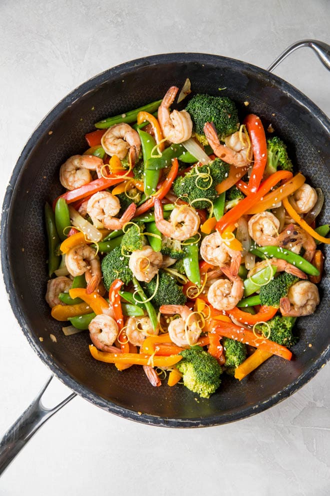 Lemon Ginger Shrimp Stir Fry is a simple and healthy meal made in less than 30 minutes! Combine your favorite stir fry vegetables and flavors to create this easy dinner recipe. #healthy #stirfry #seafood #shrimp #dinner #recipe