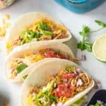 Easy shredded chicken tacos made in the slow cooker or crockpot with only a few ingredients! Create a dinner the entire family will love. #family #dinner #chicken #tacos #recipe #healthy