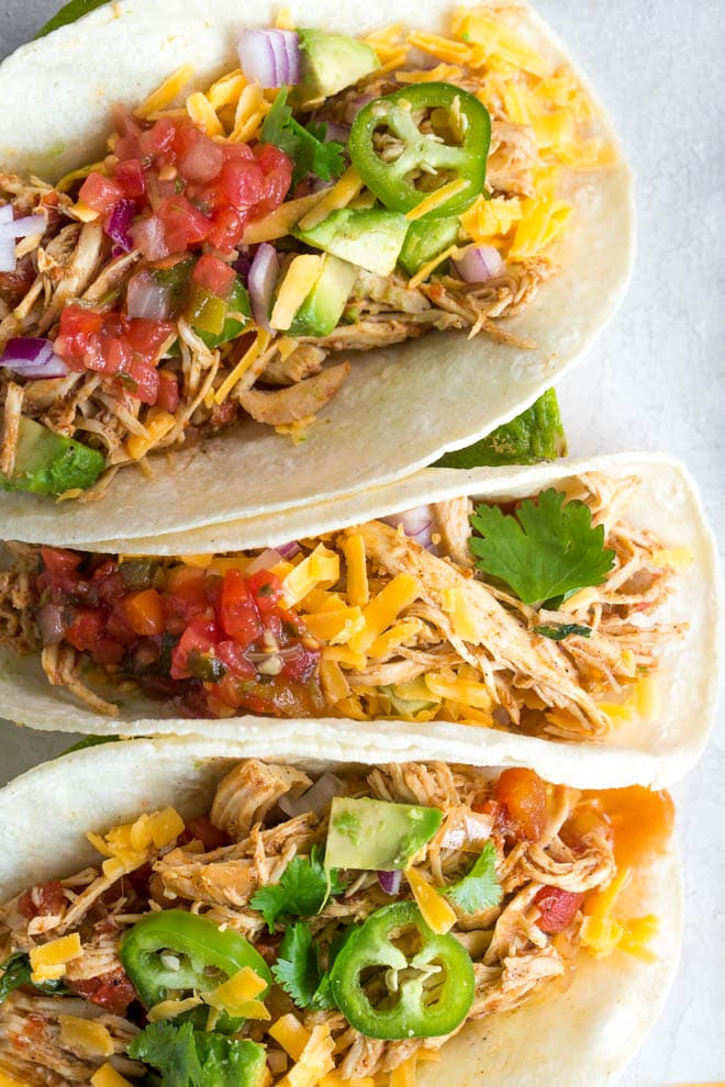 Crockpot chicken tacos are made with only a few ingredients to make dinner easy! Add your favorite taco toppings to create your own combination of flavors. #taco #chicken #recipe #slowcooker #crockpot #dinner #mealprep