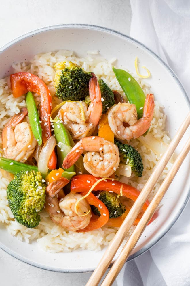 Shrimp Stir Fry with Lemon and Ginger is a simple and healthy meal made in less than 30 minutes! Combine your favorite stir fry vegetables and flavors to create this easy dinner recipe. 