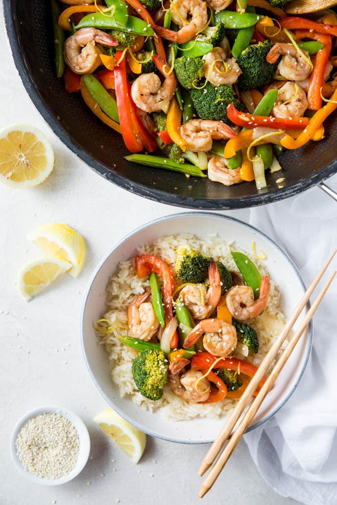 Lemon Ginger Shrimp Stir Fry is a simple and healthy meal made in less than 30 minutes! Combine your favorite stir fry vegetables and flavors to create this easy dinner recipe. #lemon #ginger #shrimp #stirfry #recipe #healthy #dinner