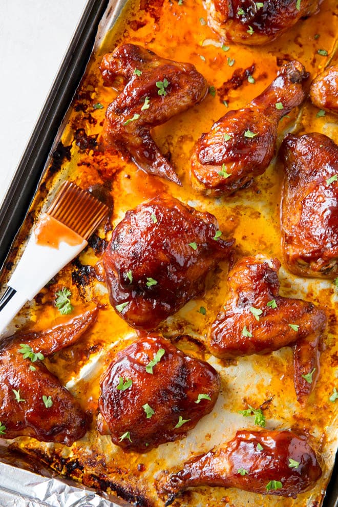 Baked bbq chicken includes a simple seasoning and easy bbq sauce that coasts wings, thighs and drumsticks that are baked in the oven. #bbq #chicken #wings #thighs #drumsticks #homemade #healthy #recipe