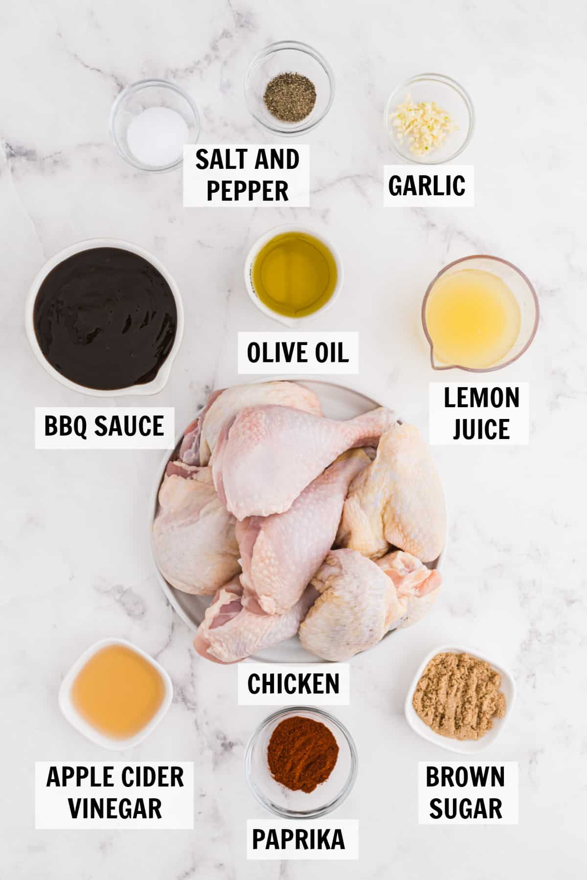 all of the ingredients for baked bbq chicken on a white counter