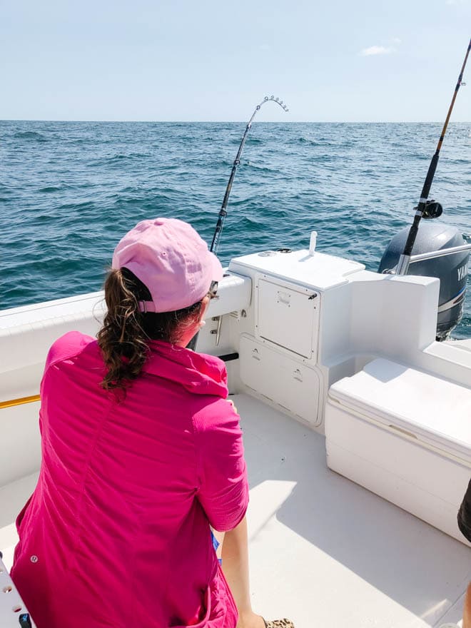 Deep sea fishing over the side of a boat.