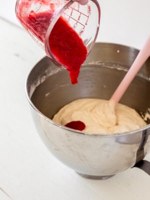 Pour strawberry sauce into cupcake batter.