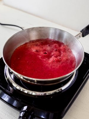 Strawberry sauce in a pan on the stove.