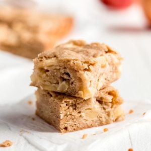 Two apple blondies on a white background.