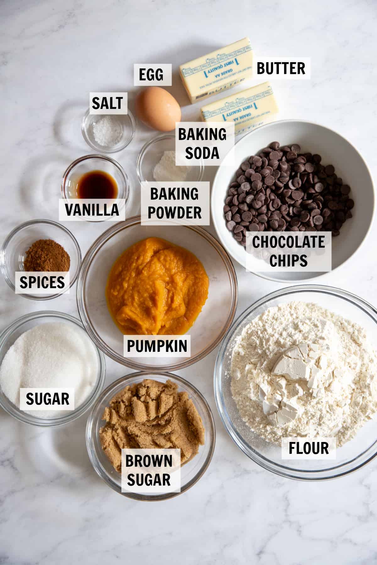 all of the ingredients for pumpkin chocolate chip cookies on a white tabletop