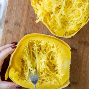 scooping out spaghetti squash