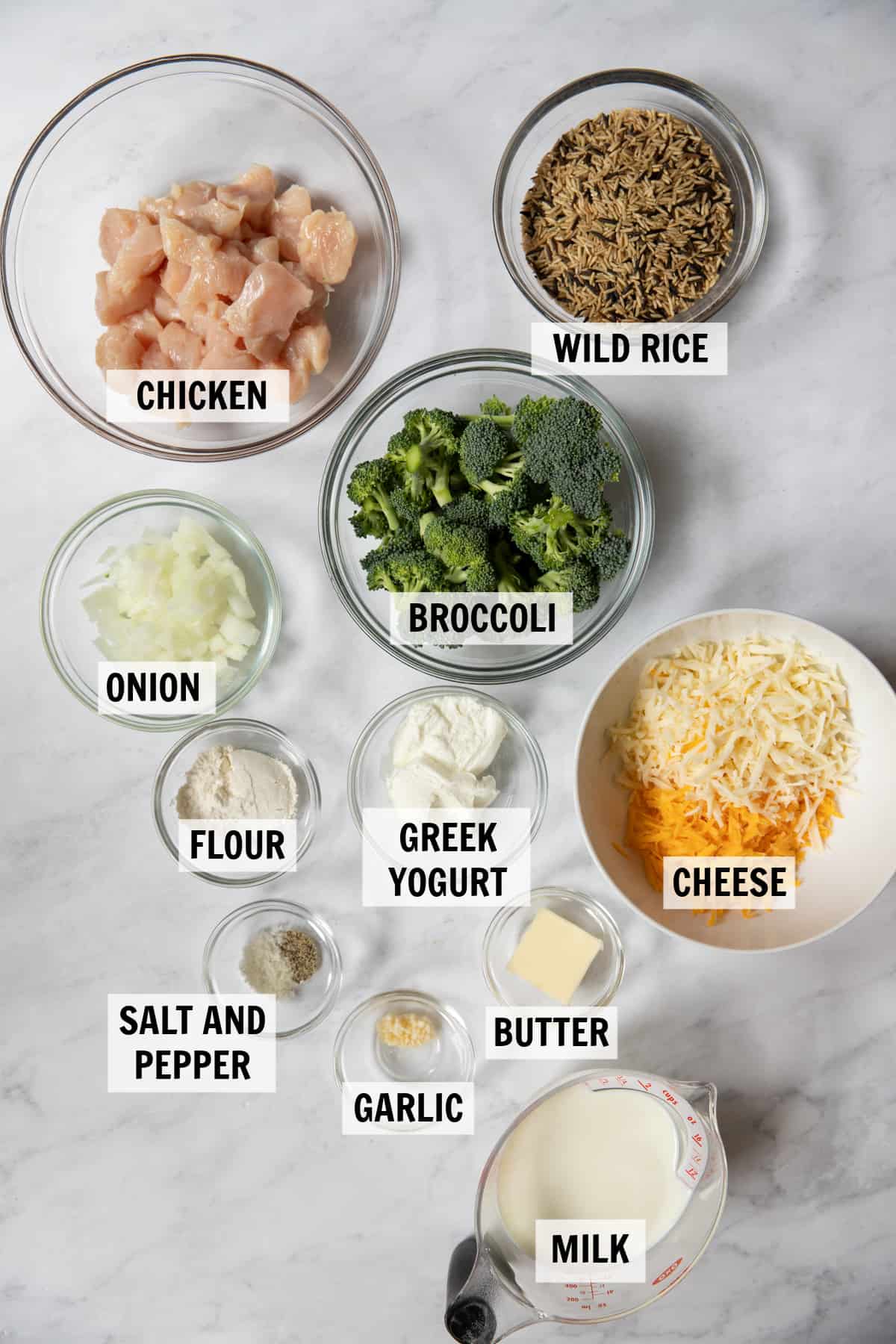 all of the ingredients for chicken broccoli and rice casserole on a white tabletop