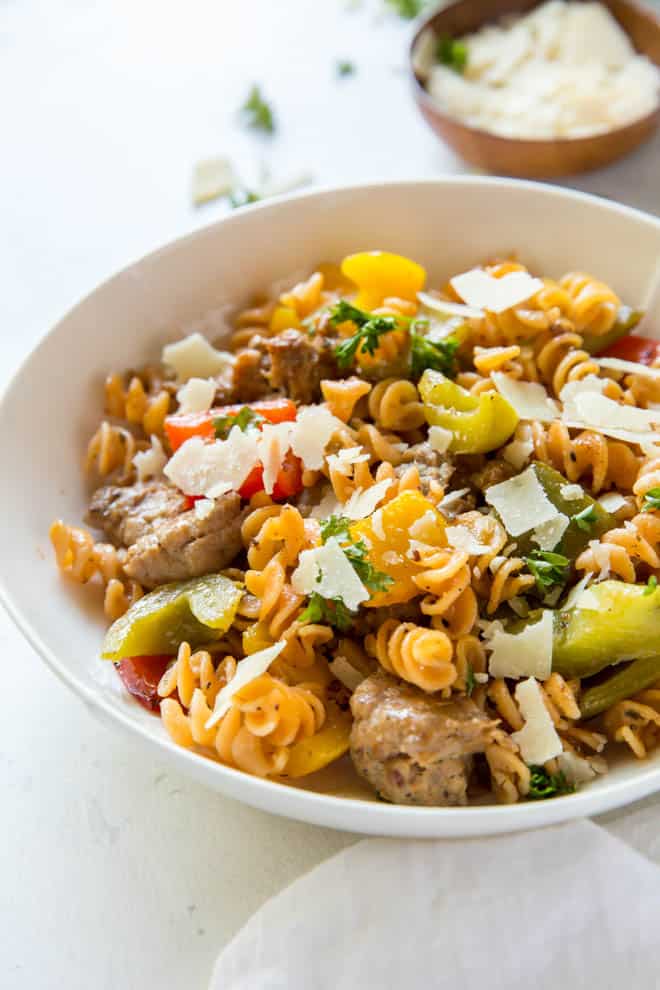 bowl with sausage and pepper fusilli with Parmesan cheese