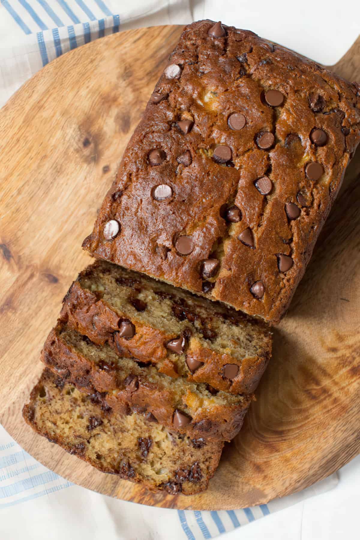 Three slices of banana bread on a wood cutting board