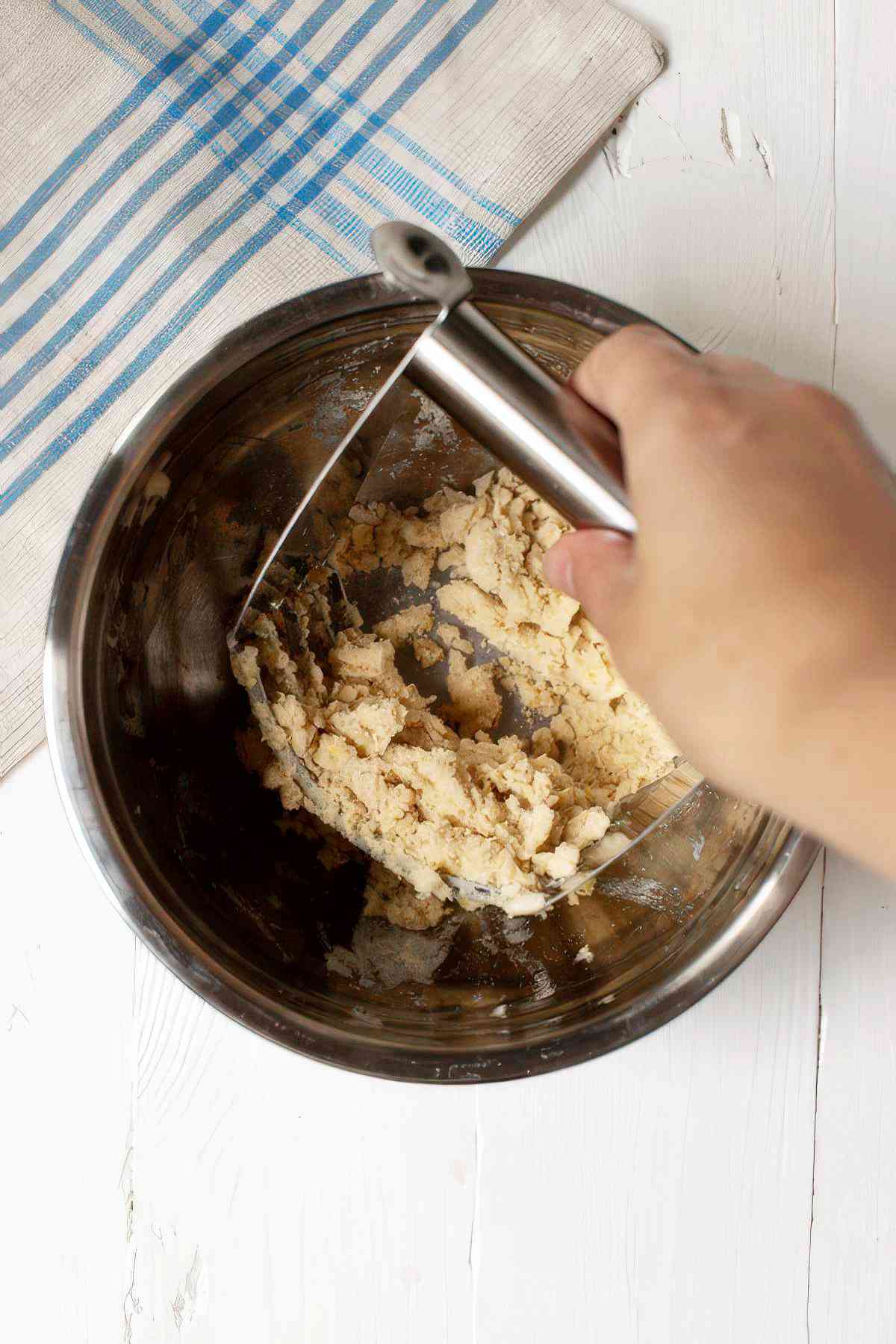 Cutting butter into flour mixture to make crumble topping for blackberry muffins