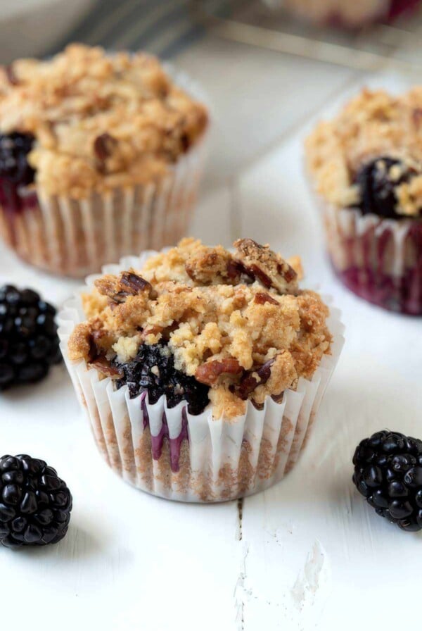 Easy blackberry muffin with crumble topping and visible juicy blackberry filling