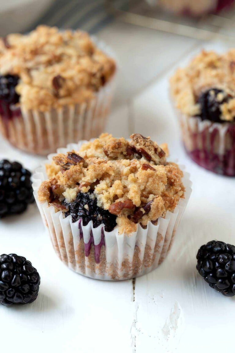 Easy blackberry muffin with crumble topping and visible juicy blackberry filling
