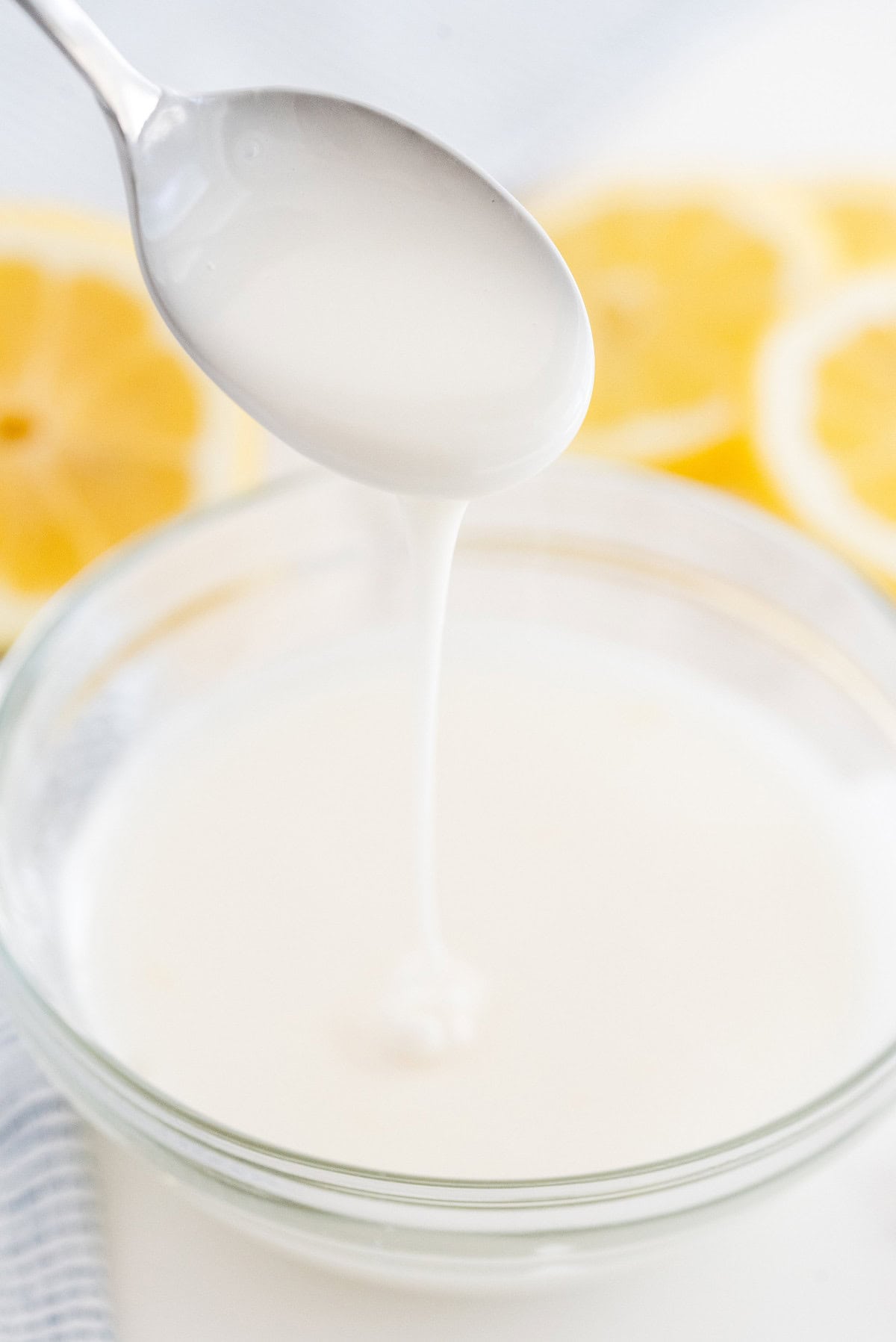 Simple lemon glaze being mixed in a bowl for lemon loaf cake.