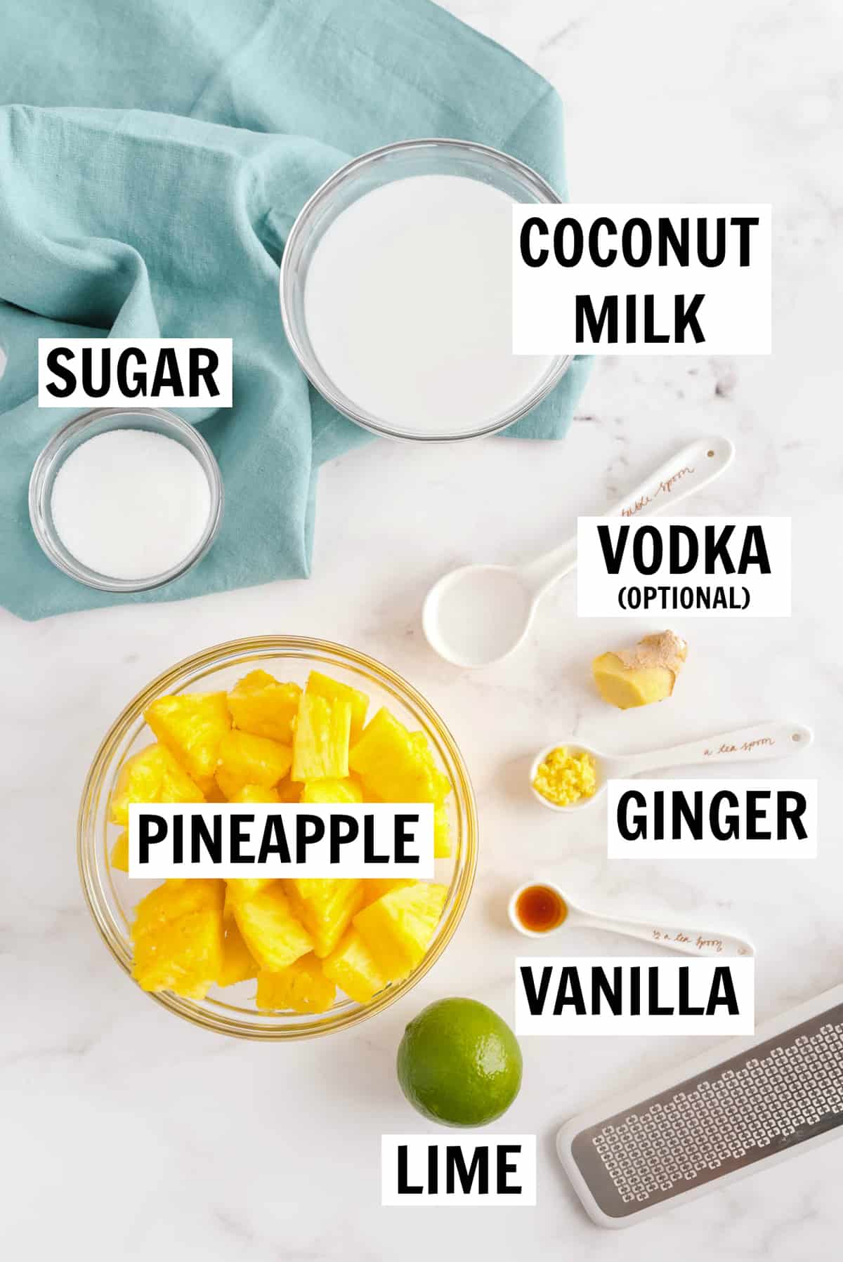 ingredients for pineapple sherbet on a table including pineapple, coconut milk, sugar, vodka, ginger, vanilla and lime
