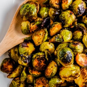 a white plate filled with roasted brussels sprouts
