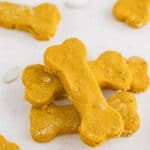 a stack of homemade dog treats on a white table